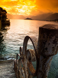 Scenic view of sea against dramatic sky during sunset