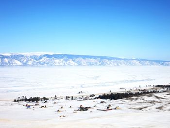 Scenic view of snowcapped mountains against clear blue sky