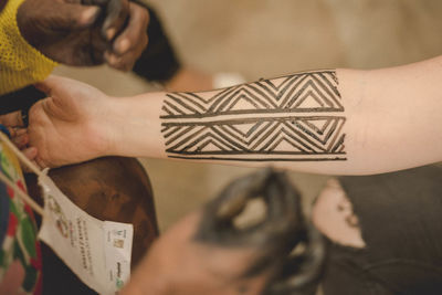 High angle view of woman playing with paper
