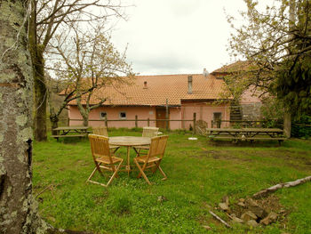 Houses by trees against sky