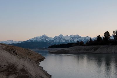 Scenic view of lake and mountains against clear sky