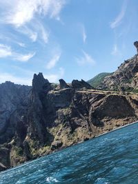 Scenic view of sea and mountains against sky