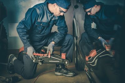 Man repairing car at garage