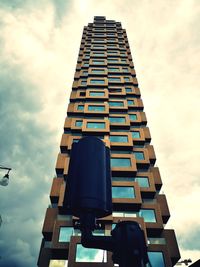 Low angle view of building against cloudy sky