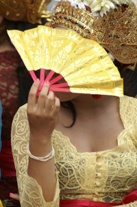 Rear view of woman holding umbrella