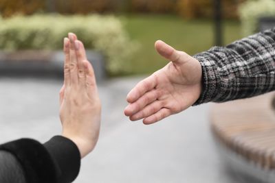 Cropped image of couple holding hands