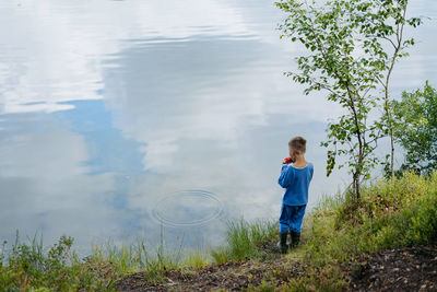 Rear view of boy standing on field