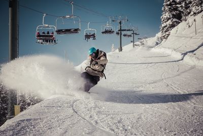 Ski lift in snow covered mountain