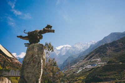 Low angle view of statue against sky