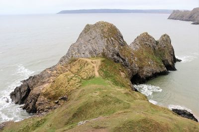 High angle view of rocks and cliffs on sea shore