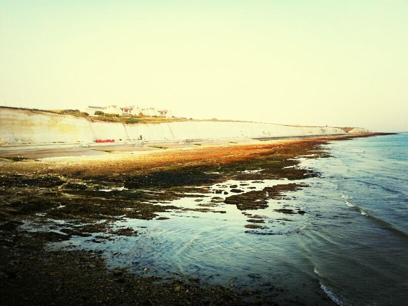 water, sea, clear sky, beach, copy space, shore, horizon over water, tranquil scene, scenics, tranquility, beauty in nature, nature, leisure activity, lifestyles, vacations, incidental people, sand, men, waterfront