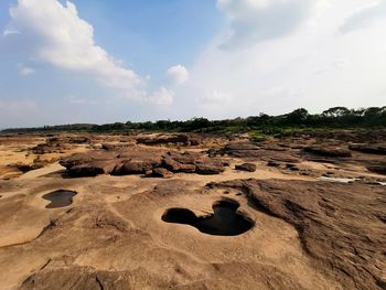 Scenic view of rocks on land against sky