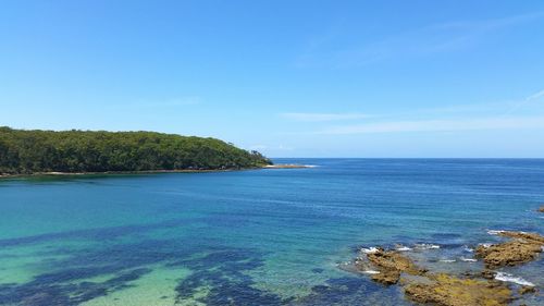 Scenic view of river against blue sky