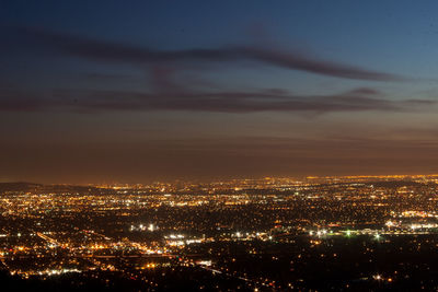 High angle view of illuminated buildings against sky at night