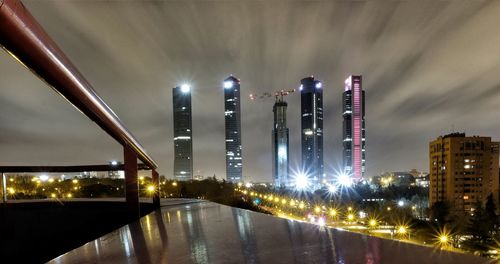 Illuminated buildings against sky at night