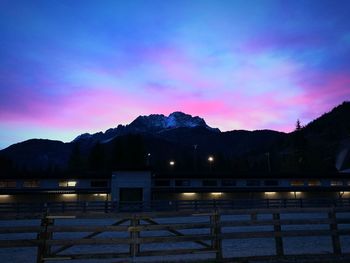 Illuminated mountain against sky at sunset