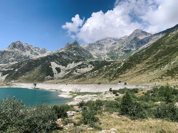 Scenic view of lake and mountains against sky