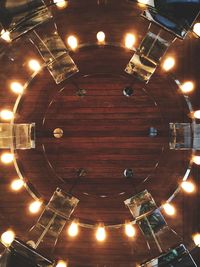 Low angle view of illuminated pendant lights hanging from ceiling