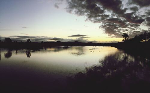 Scenic view of calm lake at sunset