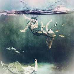 Digital composite image of swimming underwater