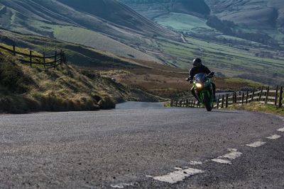 Biker riding motorcycle on road