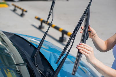 Midsection of woman holding umbrella