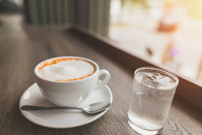 Close-up of cappuccino served on table