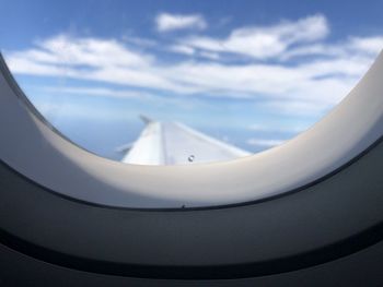 Airplane wing against sky