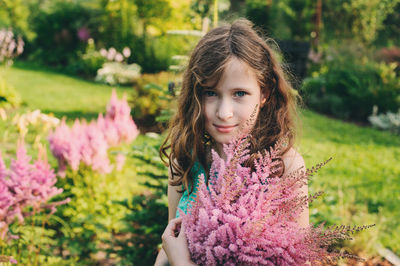 Portrait of a girl with pink flower