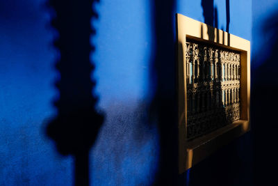 Close-up of illuminated building against blue sky