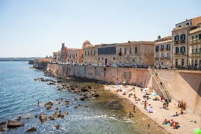 Buildings in city against clear sky