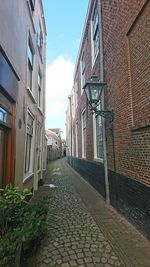 Walkway in city against sky