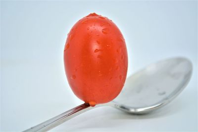 Close-up of strawberry on table against white background