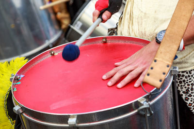 Midsection of man playing drum during festival