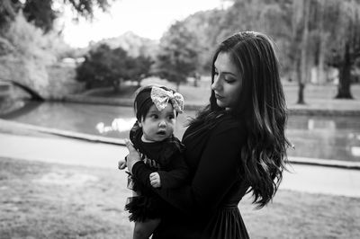 Mother and daughter standing outdoors