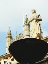 Low angle view of statue against building