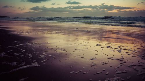 View of calm sea against cloudy sky