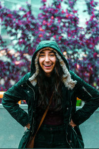 Portrait of a smiling young woman standing during winter