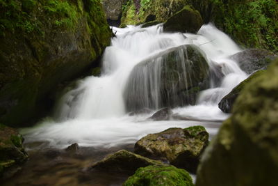Stream flowing through rocks in forest