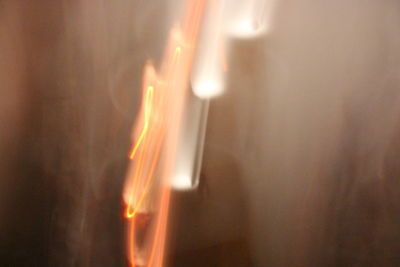 Close-up of illuminated candles on wall