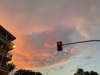 Low angle view of street light against sky at sunset