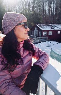 Portrait of young woman sitting on snow