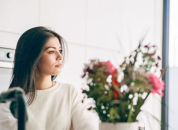 Portrait of beautiful young woman at home