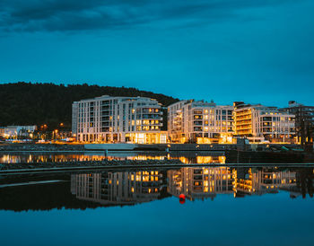 Reflection of illuminated buildings in river at night