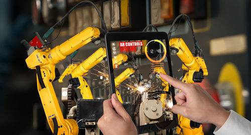 Midsection of man working at machine