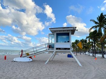 Lifeguard hut on beach against sky