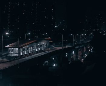 High angle view of illuminated city against sky at night