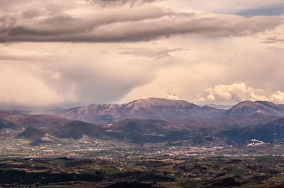 Scenic view of mountains against cloudy sky