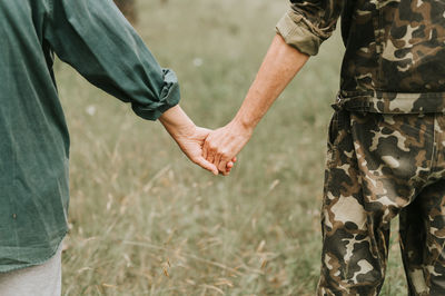 Happy senior couple holding hands. hands of man and woman hold each other. romance and love