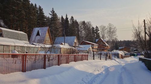 Snow covered street amidst buildings